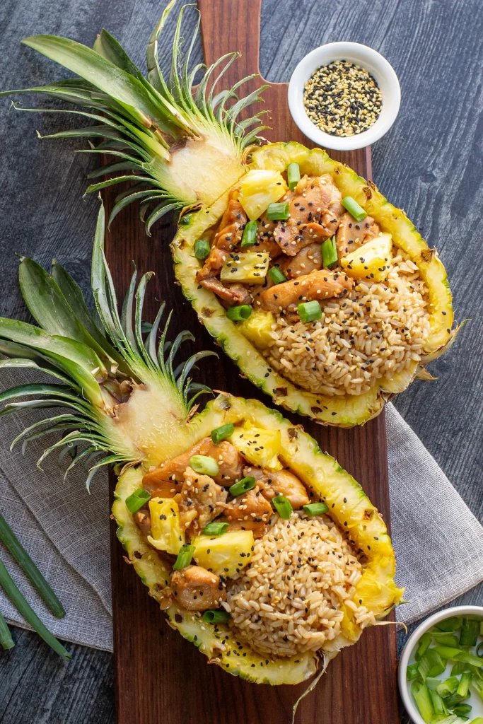 overhead shot of Chicken Teriyaki Pineapple Bowls with Brown Rice in pineapple boats
