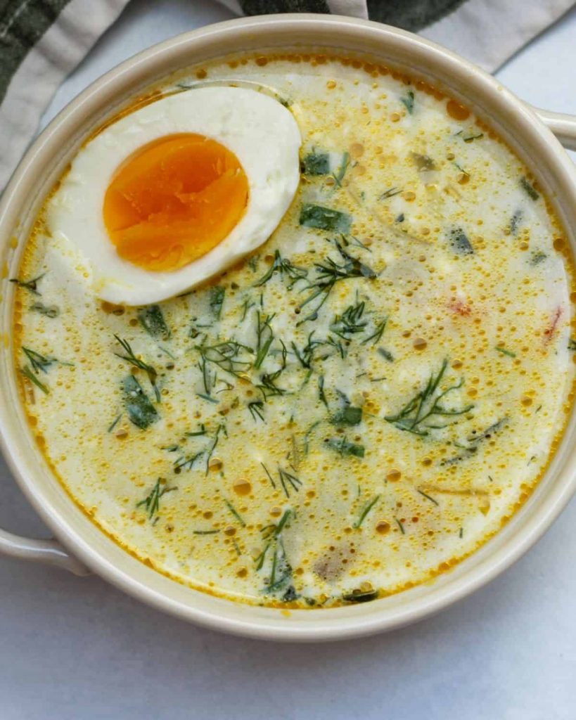 overhead shot of Green Borscht (Ukrainian Sorrel/Spinach Soup Recipe with half a soft boiled egg