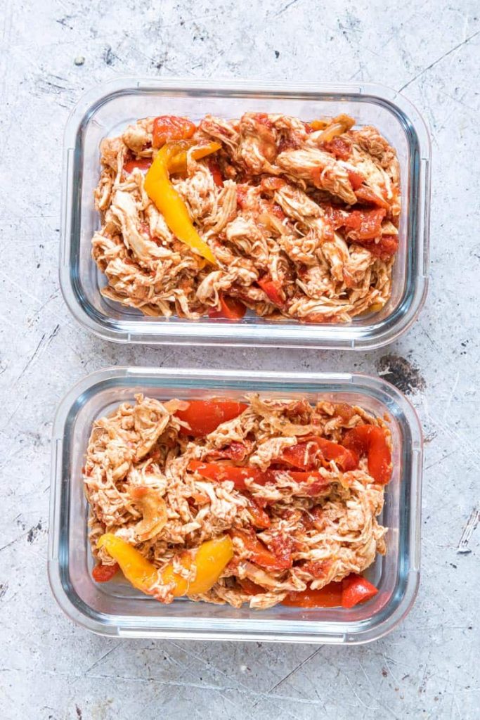 overhead shot of Instant Pot Chicken Fajitas in glass meal prep containers