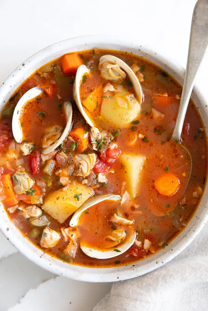 Manhattan Clam Chowder in a white bowl with a silver spoon