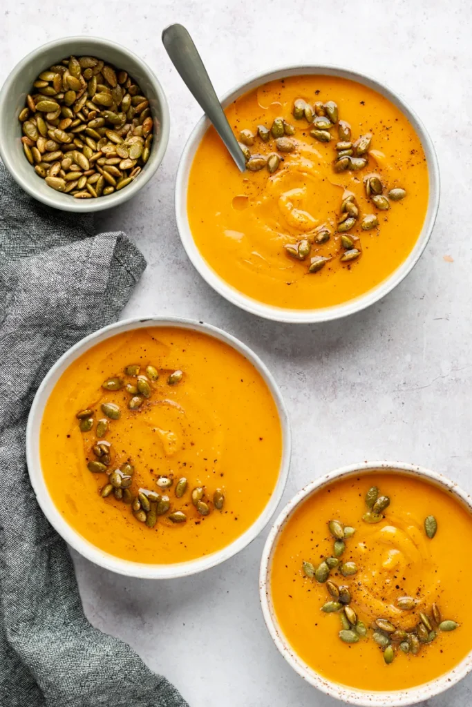overhead Instant Pot Pumpkin Soup garnished with pumpkin seeds