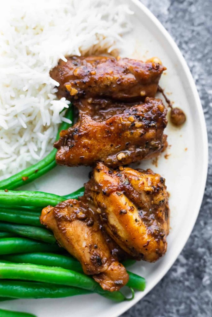 Balsamic Chicken on a round white plate with white rice and steamed green beans - one of the recipes for this week's healthy weekly meal plan