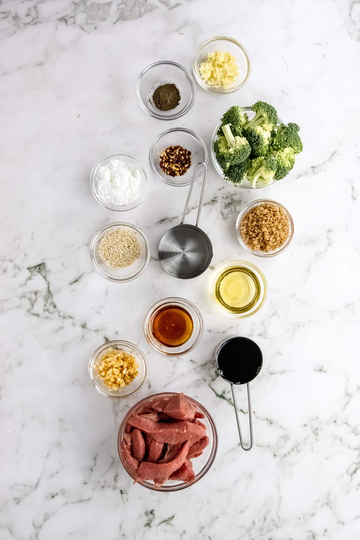 overhead shot of ingredients to make healthy beef and broccoli stir fry recipe in individual bowls