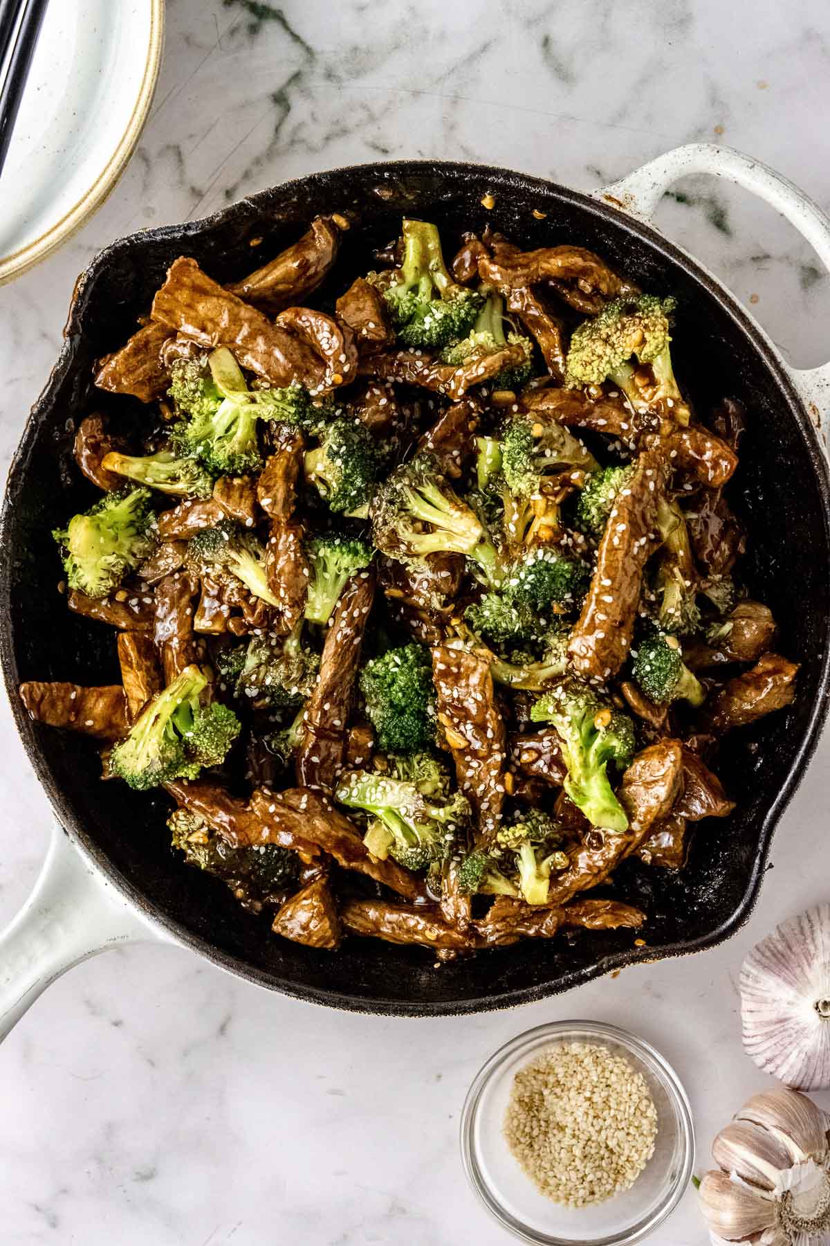 overhead shot of a beef and broccoli stir fry recipe in a cast iron skillet ready to serve