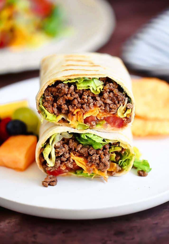 Grilled Cheeseburger Wraps cut in half and stacked on a white plate to show the inside - one of the recipes from this week's healthy weekly meal plan