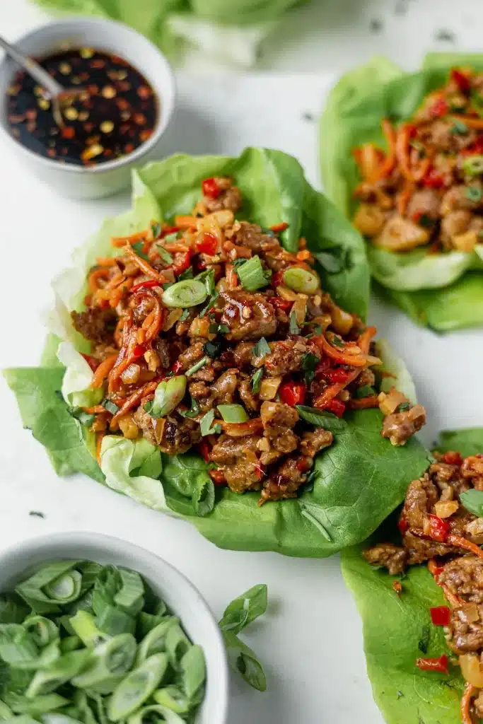 Pork Lettuce Wraps on a white surface - one of the recipes from this week's healthy weekly meal plan