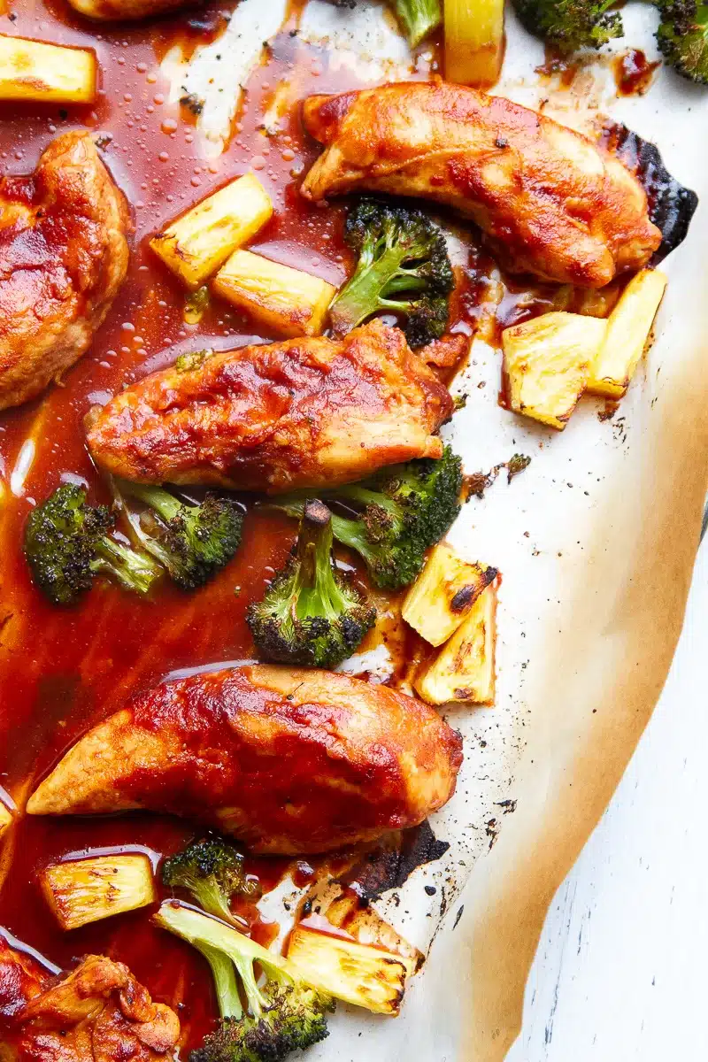 Hawaiian Sheet Pan BBQ Chicken on a baked on a sheet pan that was lined with white parchment paper - one of the recipes from this week's healthy weekly meal plan