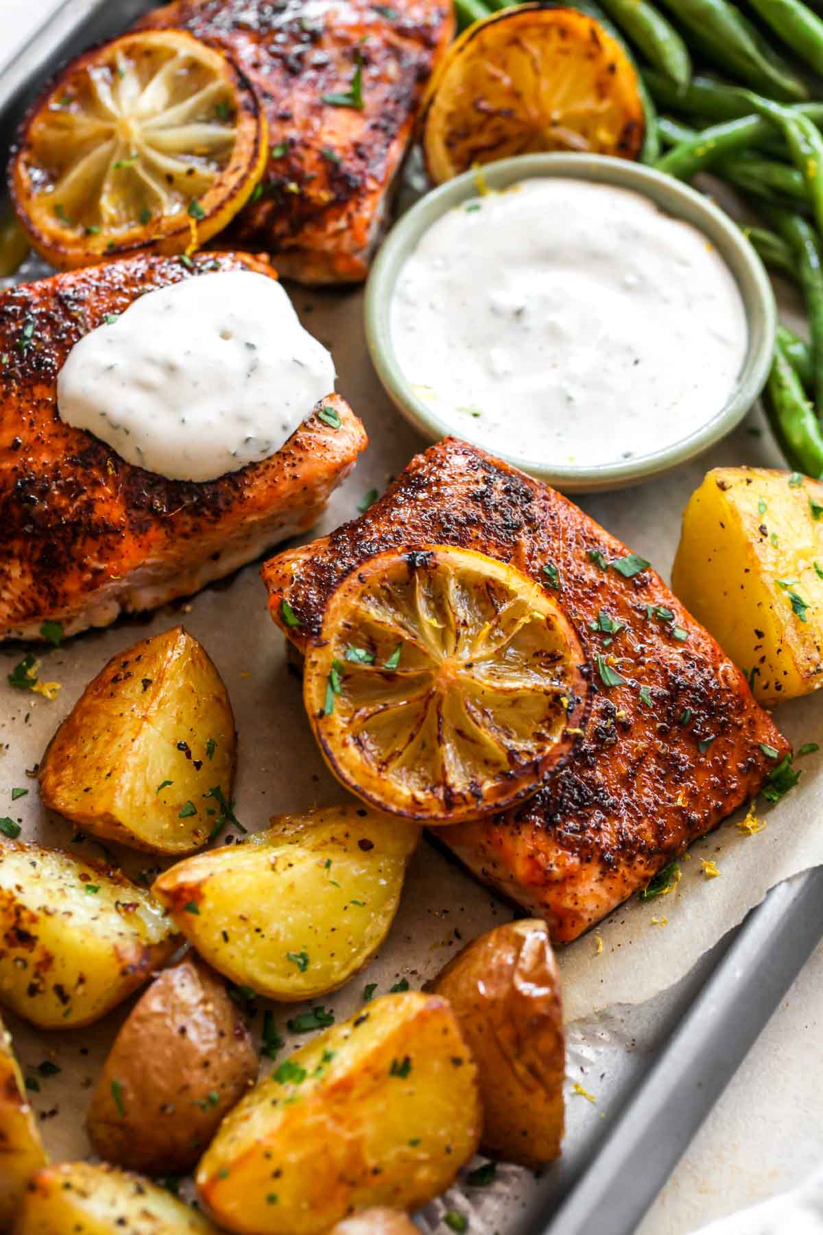 overhead shot of sheet pan salmon baked with lemon, potatoes, and green beans - one of the recipes for this week's healthy weekly meal plan