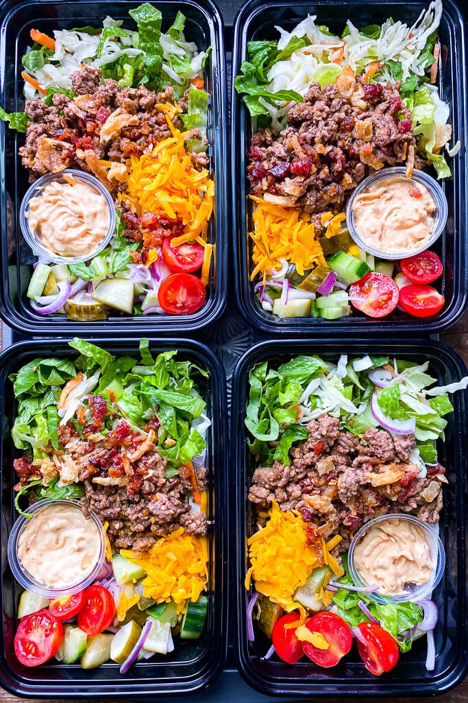 assembled bacon cheeseburger bowls in black plastic meal prep containers for this week's healthy weekly meal plan