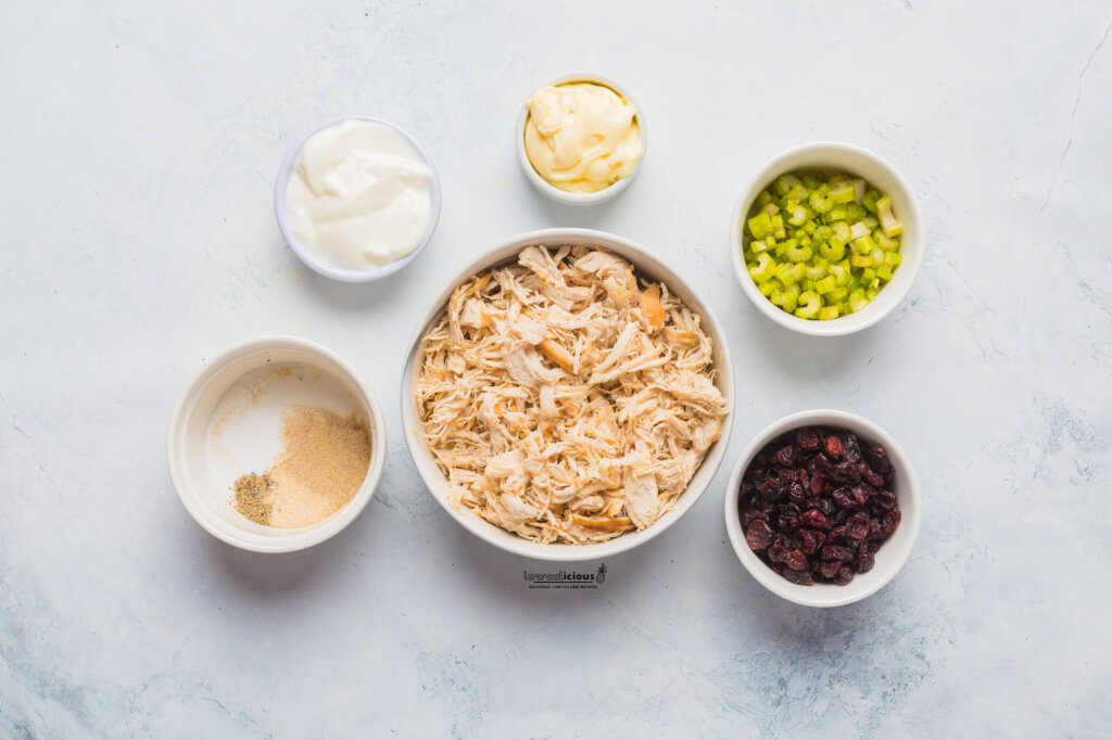 ingredients to make a low calorie Greek Yogurt Chicken Salad recipe in individual white bowls