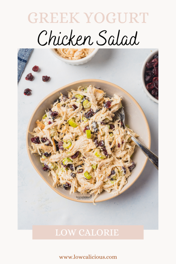 overhead shot of low calorie Greek Yogurt Chicken Salad Recipe in a bowl with a serving spoon with a pink border and text for Pinterest