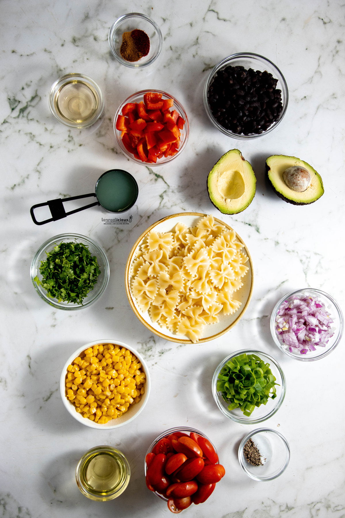 ingredients in individual bowls to make a Healthy Southwest Pasta Salad recipe (Vegan)