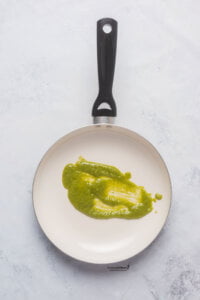 a nonstick skillet with pesto in it to make Pesto Eggs (Viral TikTok Recipe)