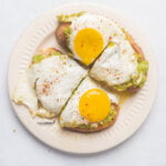 overhead shot of a finished Easy Pesto Eggs (Viral TikTok Recipe) plated on avocado sourdough toast