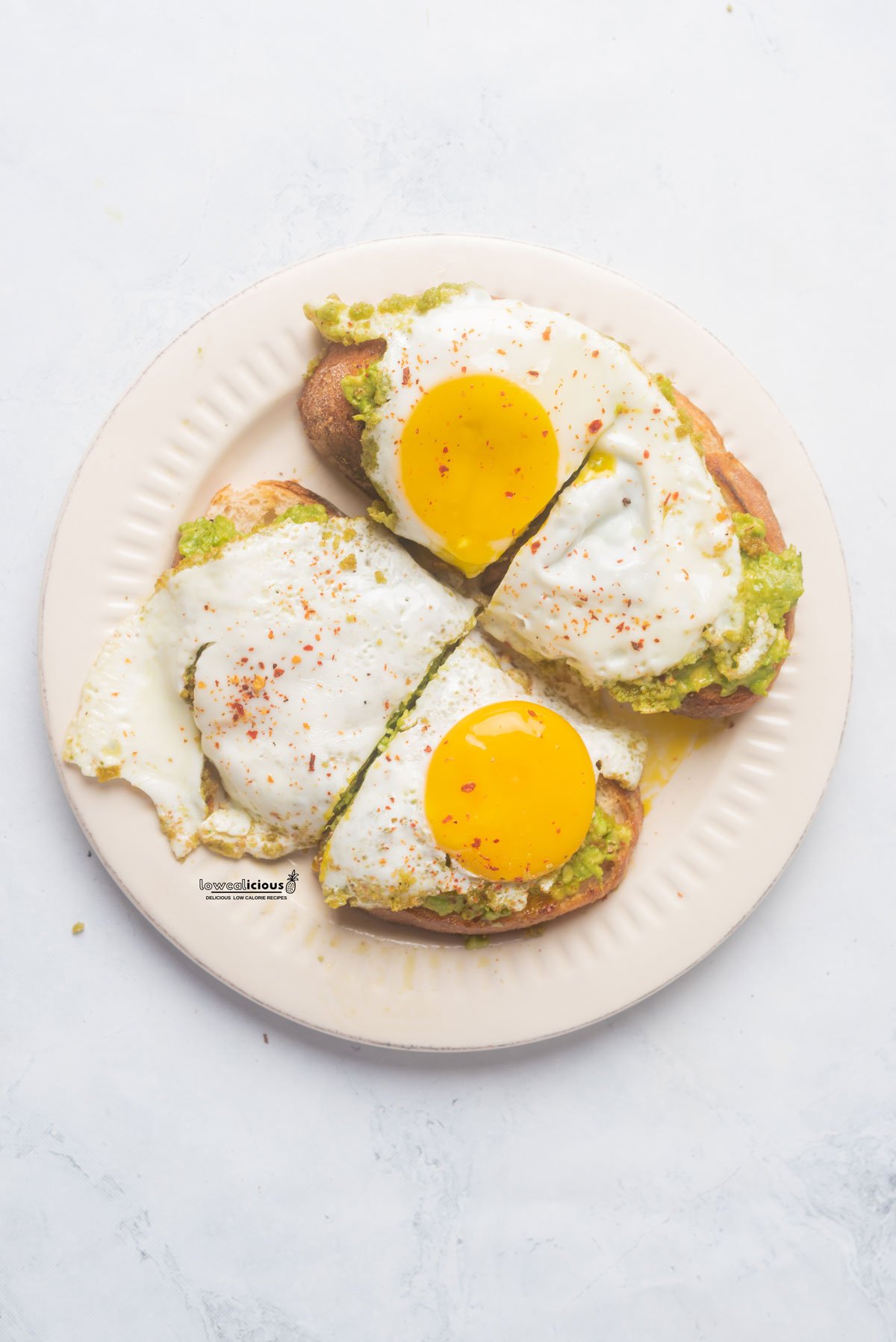 overhead shot of a finished Easy Pesto Eggs (Viral TikTok Recipe) plated on avocado sourdough toast