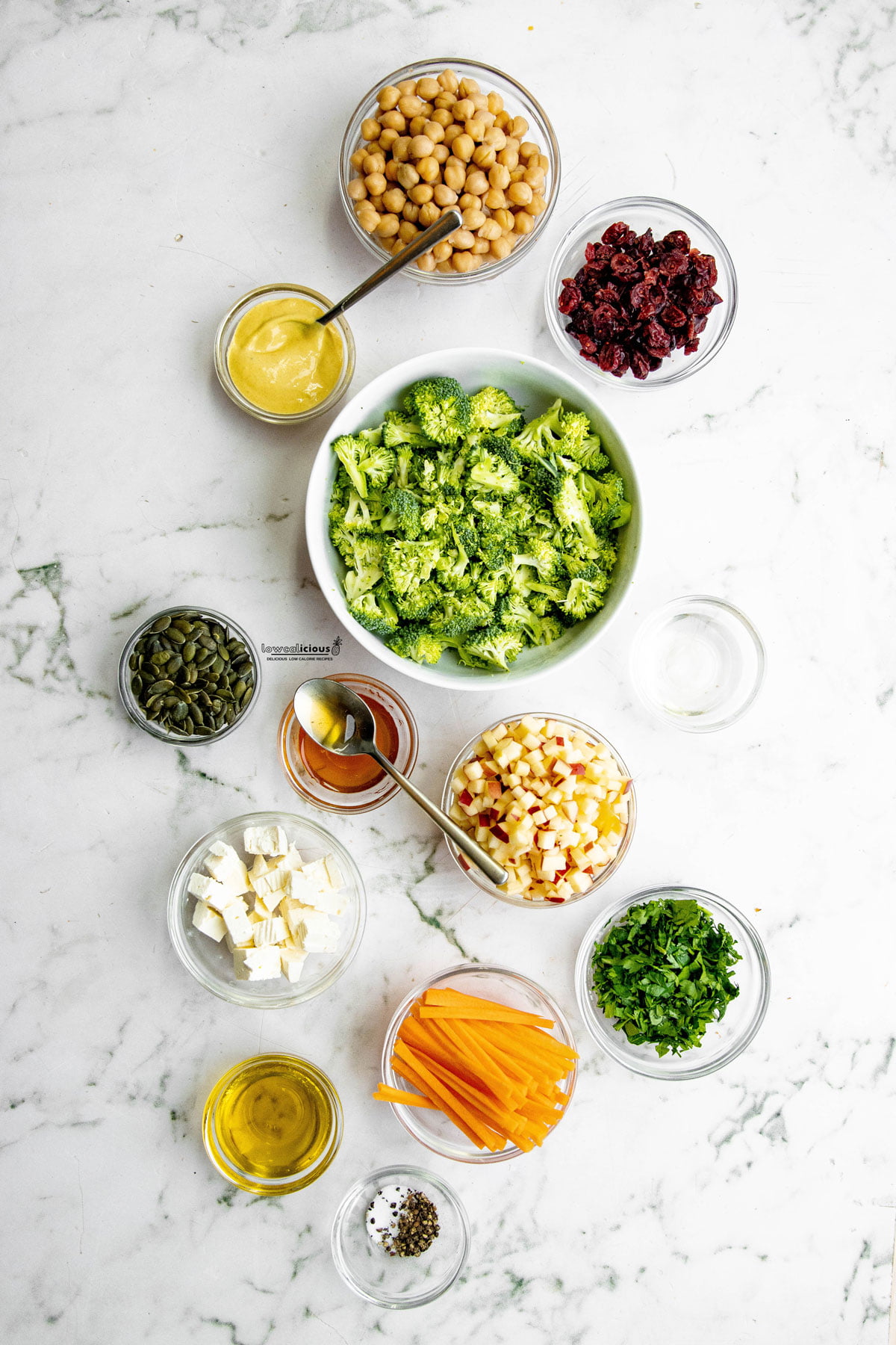 ingredients to make a Healthy Broccoli Apple Salad Recipe with Cranberries in individual bowls