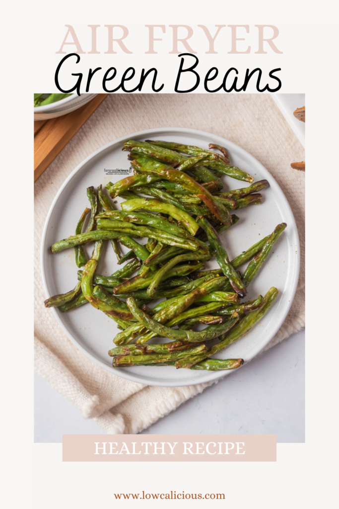overhead shot of air fryer green beans on a round white plate with text on the image for Pinterest