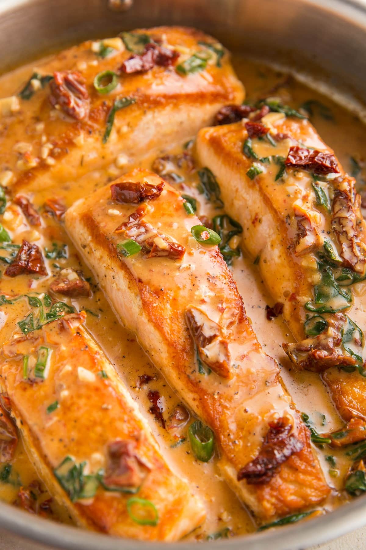 Creamy Sun Dried Tomato Salmon cooked in a large skillet - one of the recipes for this week's healthy weekly meal plan