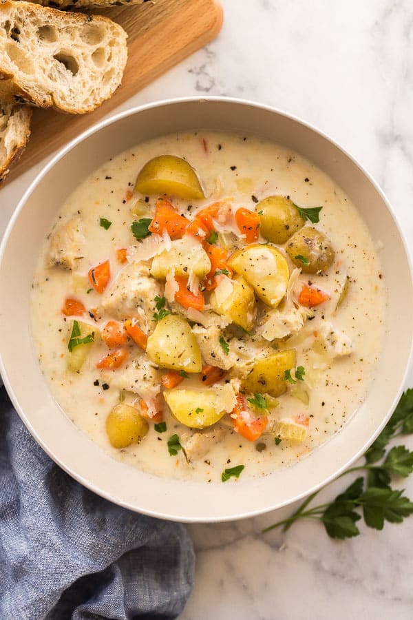 cooked slow cooker garlic parmesan chicken stew in a large white bowl - one of the recipes for this week's healthy meal plan
