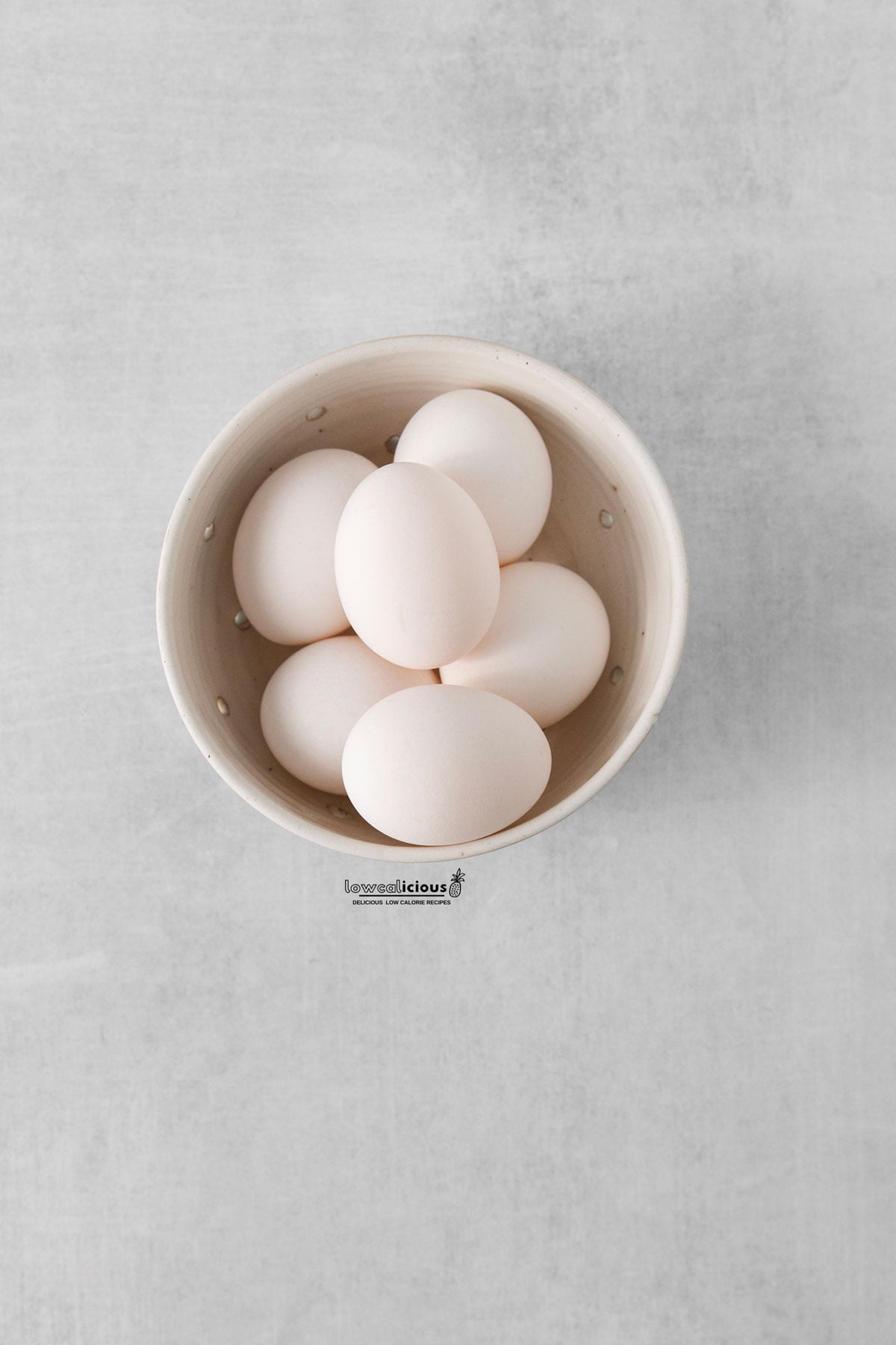 large white eggs in a round white bowl
