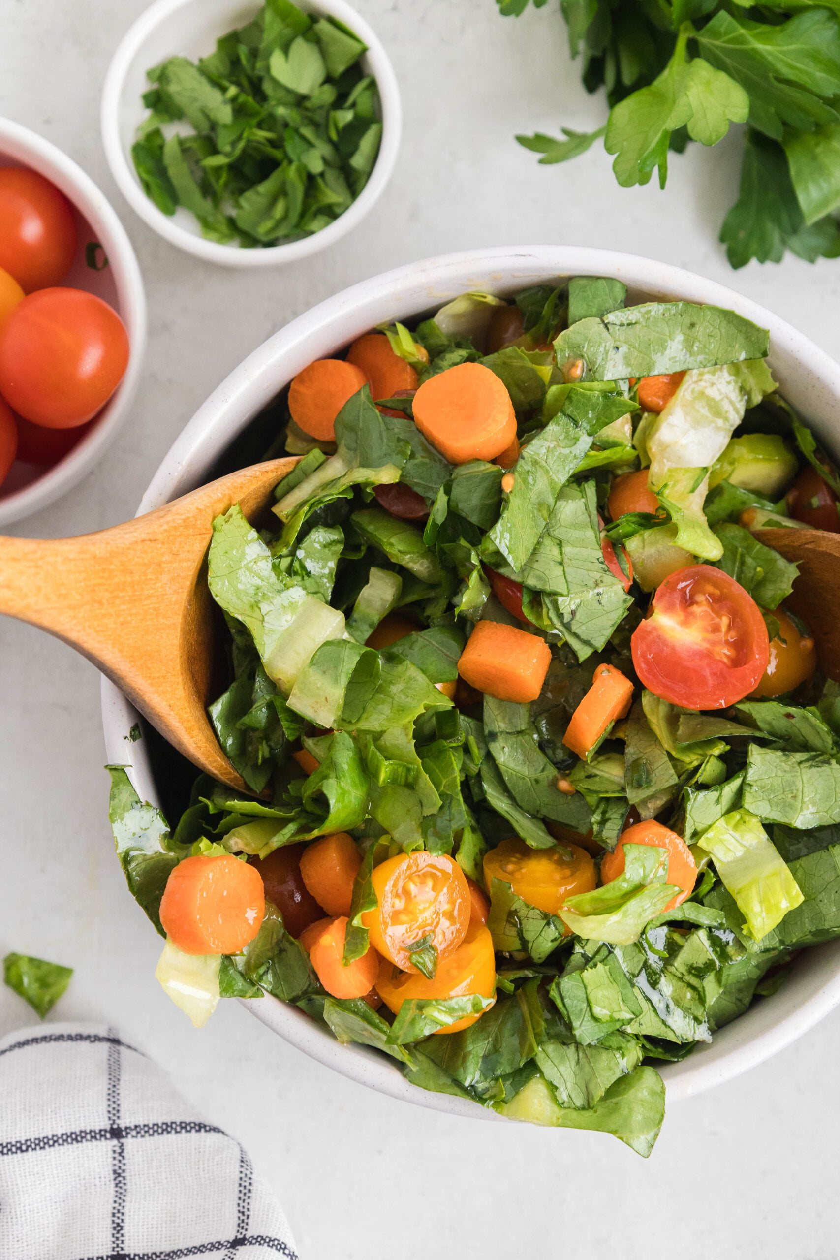 Garden Salad Recipe with Homemade Vinaigrette tossed in a large white bowl with a wood salad spoon